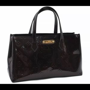 Louis Vuitton handbag bucket tote style, maroon in color